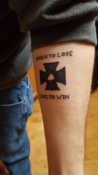 Will's cringe tattoo. It reads "Born to lose, live to win."