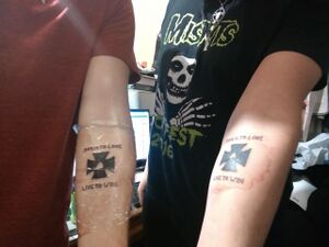 Two people bond over matching cringe tattoos